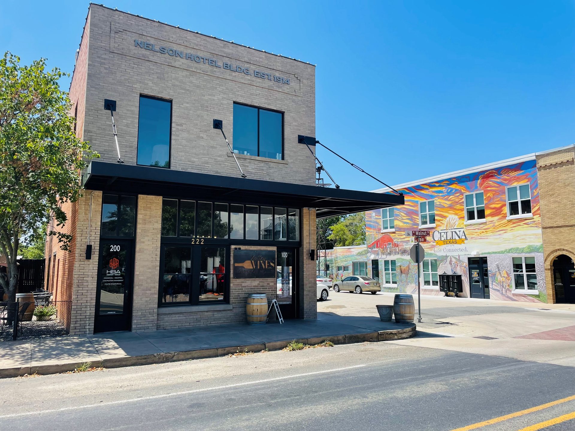 A downtown Celina storefront with a painted Celina mural on the neighboring building.