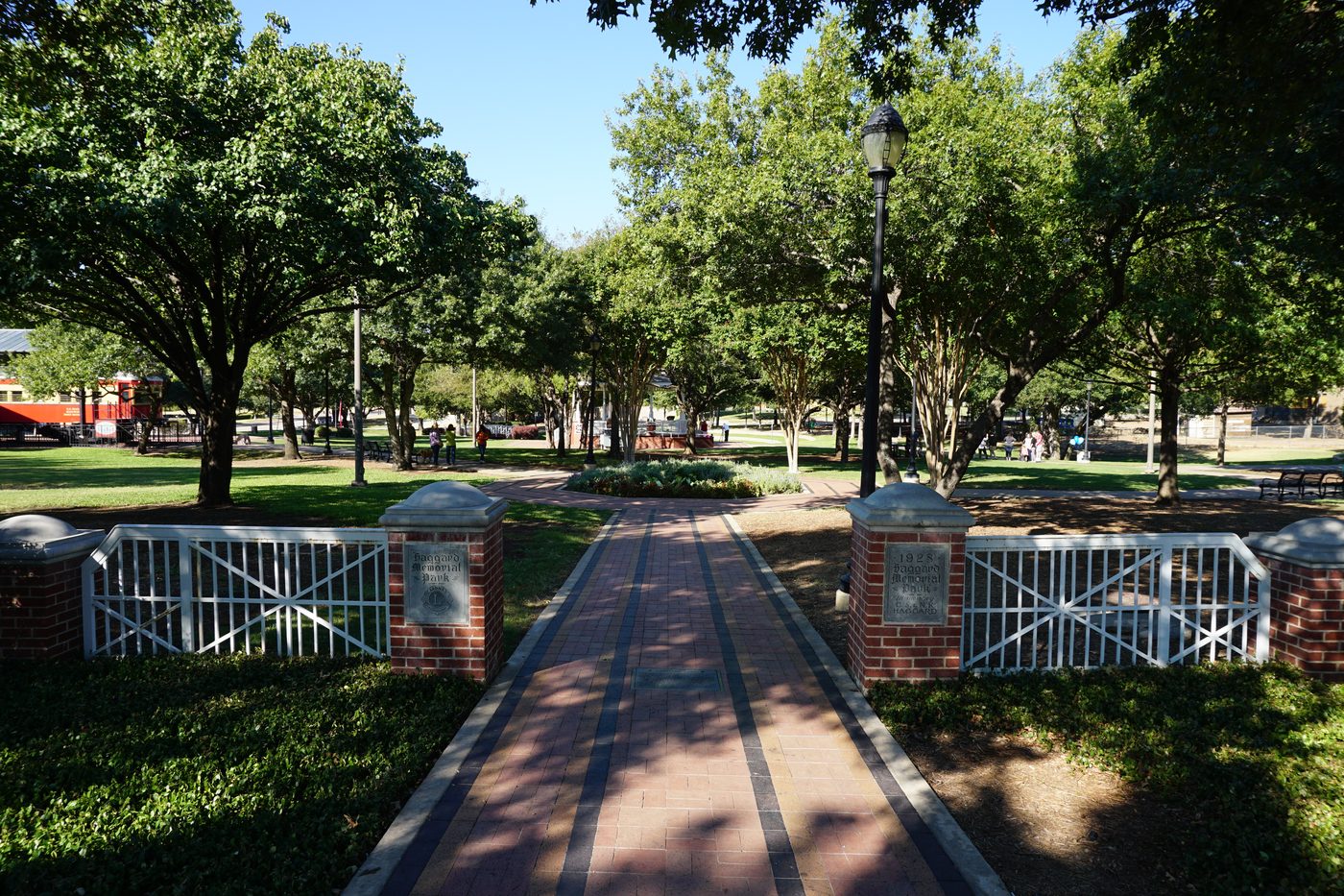 Tree-lined paths and the historic rail corridor through Haggard Park in Plano.